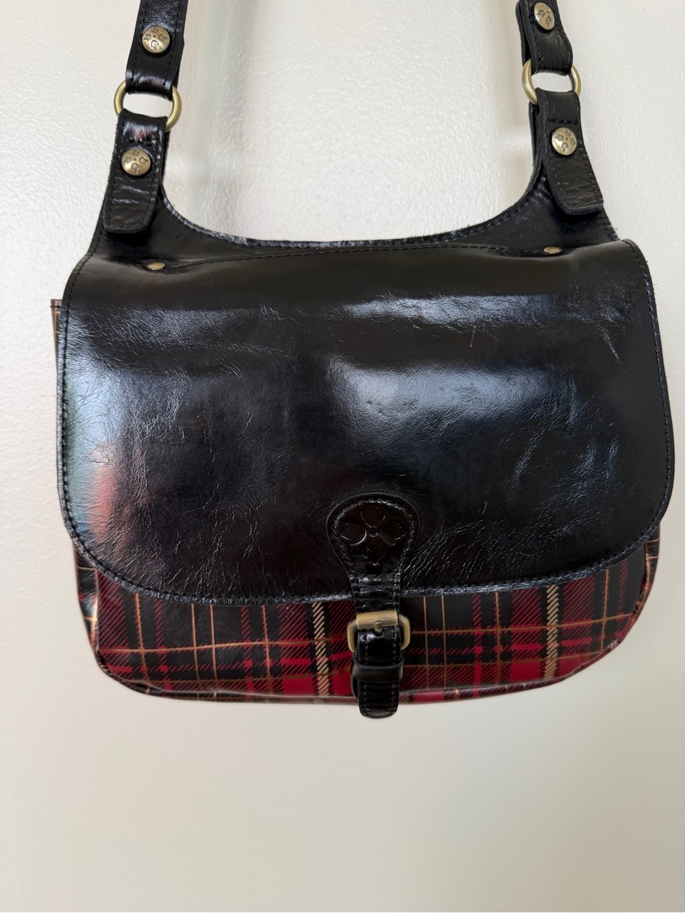 PATRICIA NASH Black Leather Crossbody Saddle Bag with Red Plaid